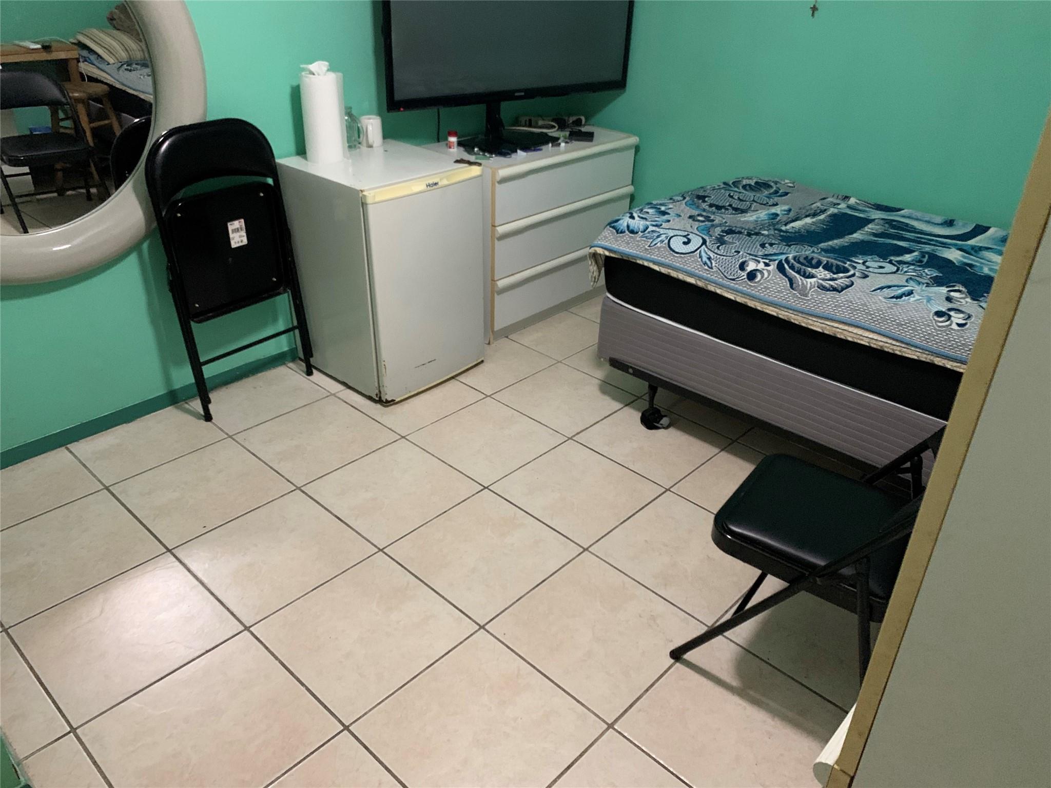 87-33 Commonwealth Boulevard Queens, NY 11426 - Photo 22 of 28 a kitchen with a stove and a refrigerator