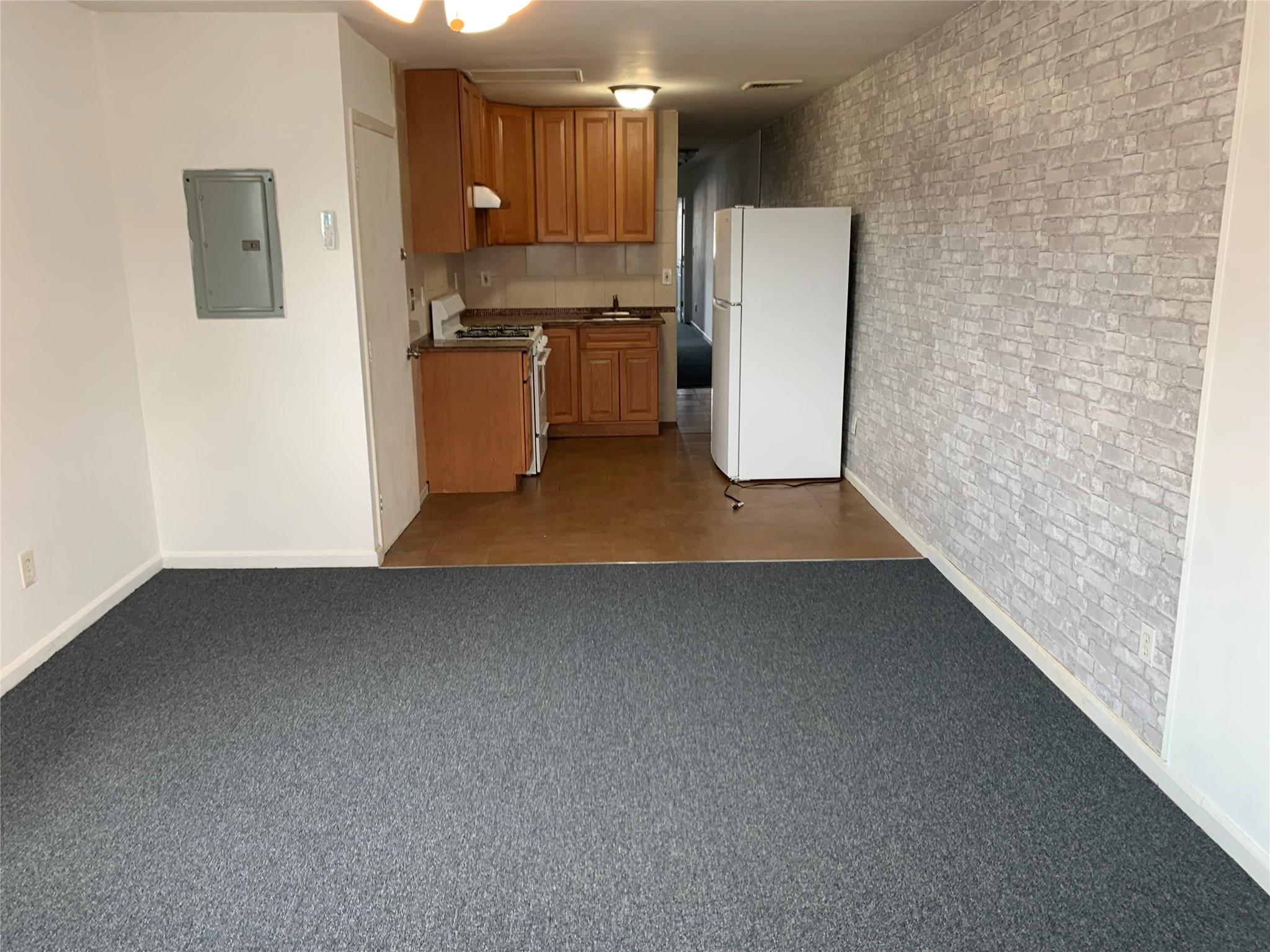 87-33 Commonwealth Boulevard Queens, NY 11426 - Photo 8 of 28 a kitchen with a refrigerator and a stove