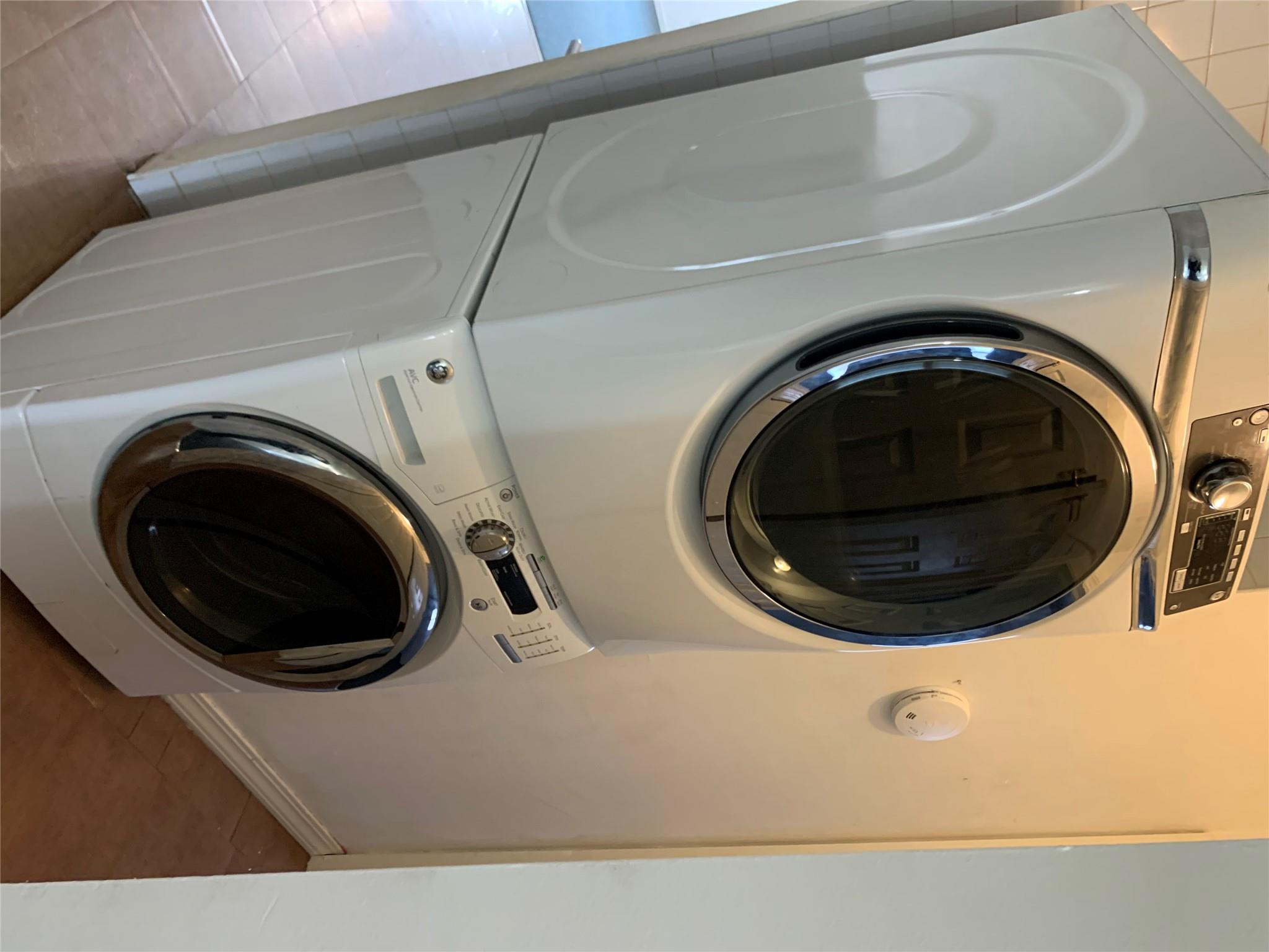 87-33 Commonwealth Boulevard Queens, NY 11426 - Photo 10 of 28 a utility room with dryer and washer