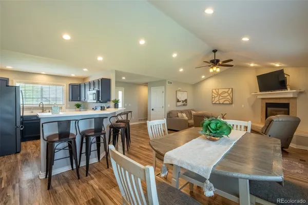 a kitchen with a sink and a stove top oven with wooden floor
