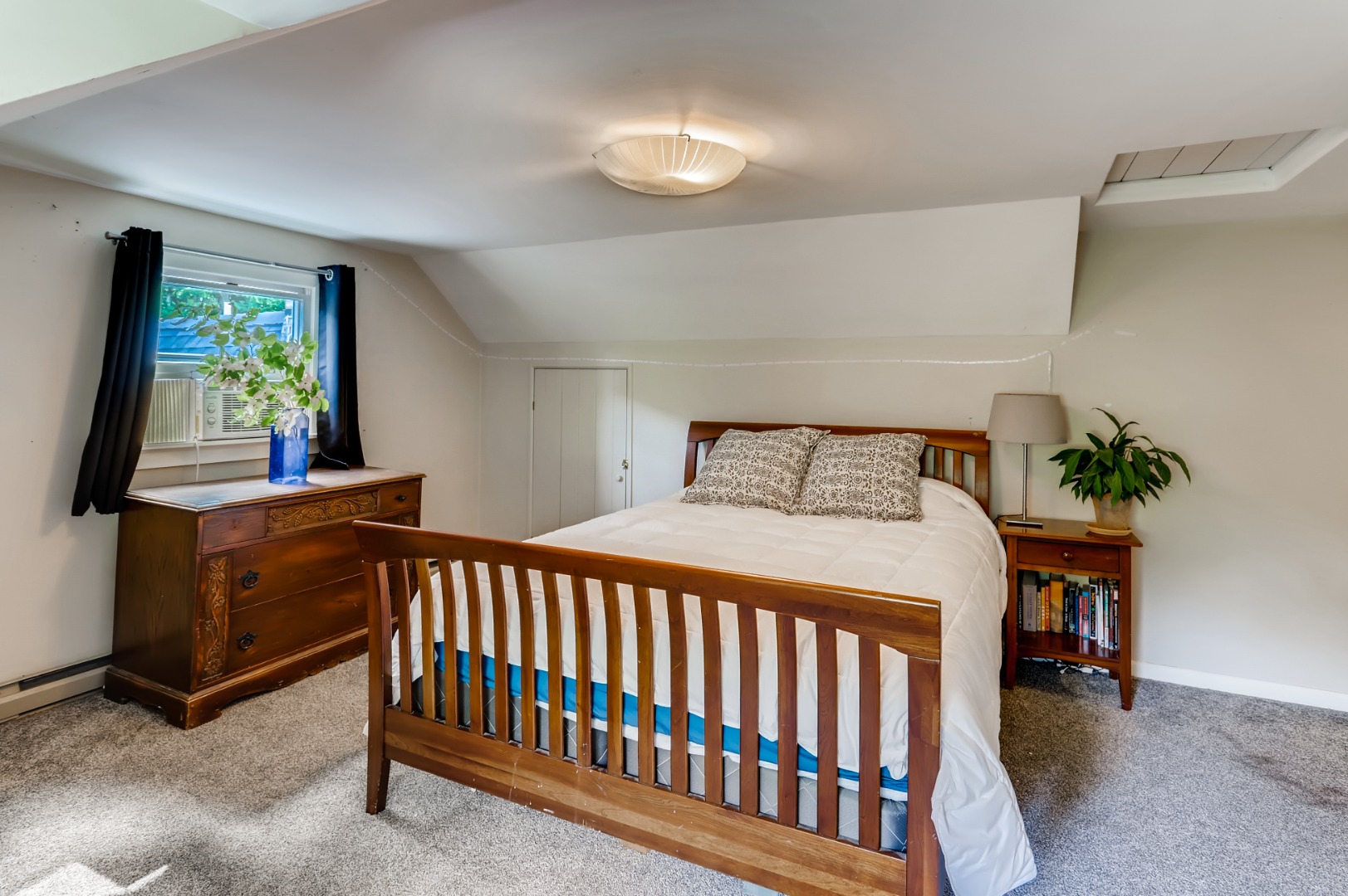 377 State Road West Tisbury, MA 02568 - Photo 19 of 36 a bedroom with a bed and a potted plant