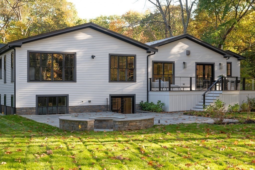 673 Wellesley Street Weston, MA 02493 - Photo 1 of 1 a white house that has a large pool in front of it