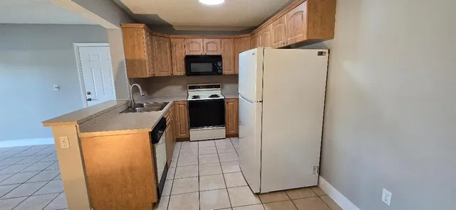 a utility room with cabinets washer and dryer