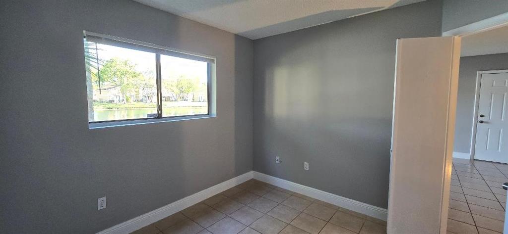 301 Palm Way, Unit 107 Pembroke Pines, FL 33025 - Photo 11 of 36 an empty room with a window
