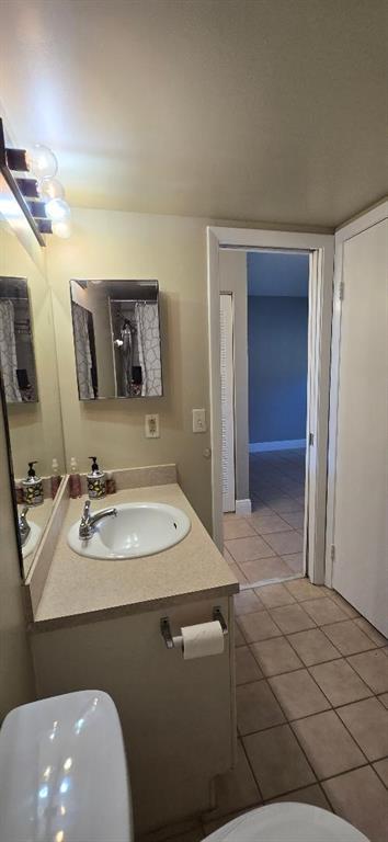 301 Palm Way, Unit 107 Pembroke Pines, FL 33025 - Photo 18 of 36 a bathroom with a sink a toilet and mirror