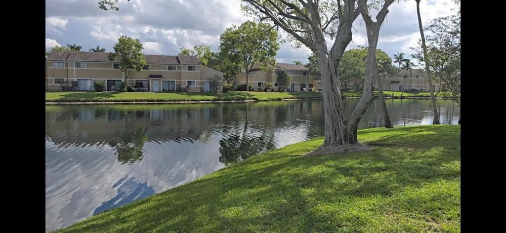 301 Palm Way, Unit 107 Pembroke Pines, FL 33025 - Photo 22 of 36 a view of a lake with a building in the background