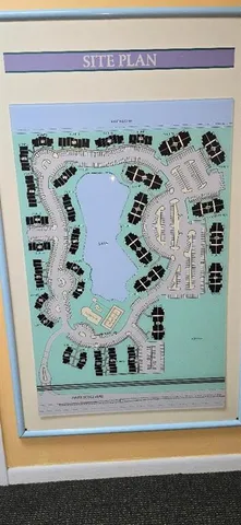 a view of a house with a yard and palm tree