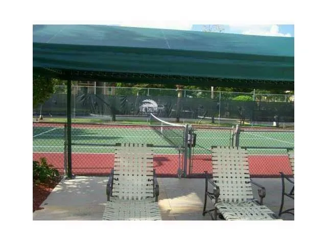 a patio with a table and chairs under an umbrella
