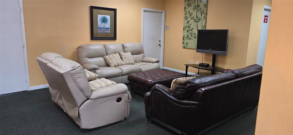 301 Palm Way, Unit 107 Pembroke Pines, FL 33025 - Photo 32 of 36 a living room with furniture and a flat screen tv