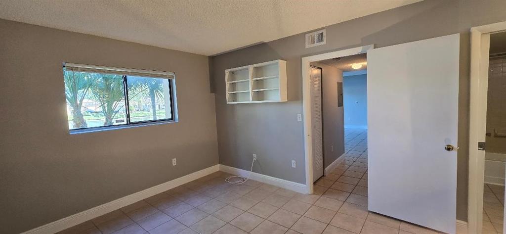 301 Palm Way, Unit 107 Pembroke Pines, FL 33025 - Photo 4 of 36 a view of an empty room with window and closet area
