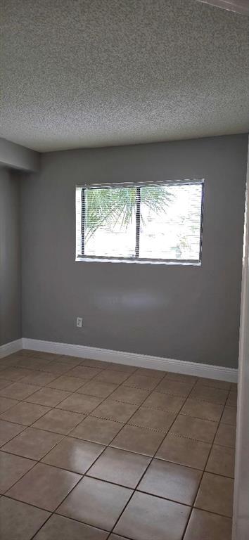 301 Palm Way, Unit 107 Pembroke Pines, FL 33025 - Photo 10 of 36 an empty room with windows