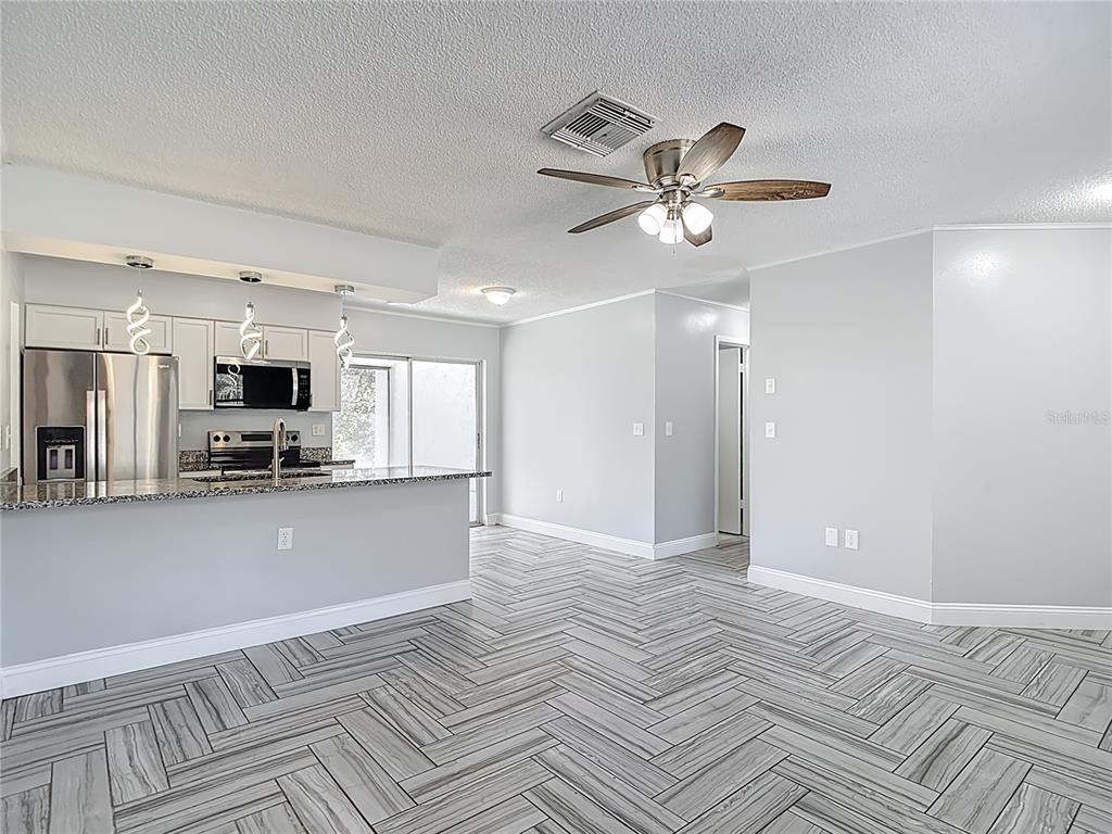 13156 Odham Street Spring Hill, FL 34609 - Photo 11 of 54 a view of a livingroom with kitchen view