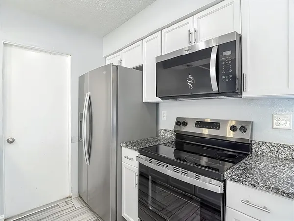 a kitchen with a stove and a microwave