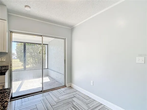a view of hallway with wooden floor