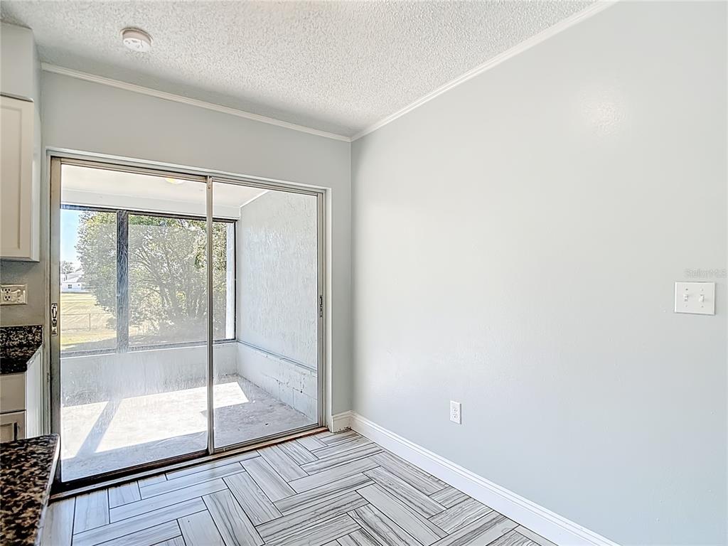 13156 Odham Street Spring Hill, FL 34609 - Photo 14 of 54 a view of an empty room with glass door