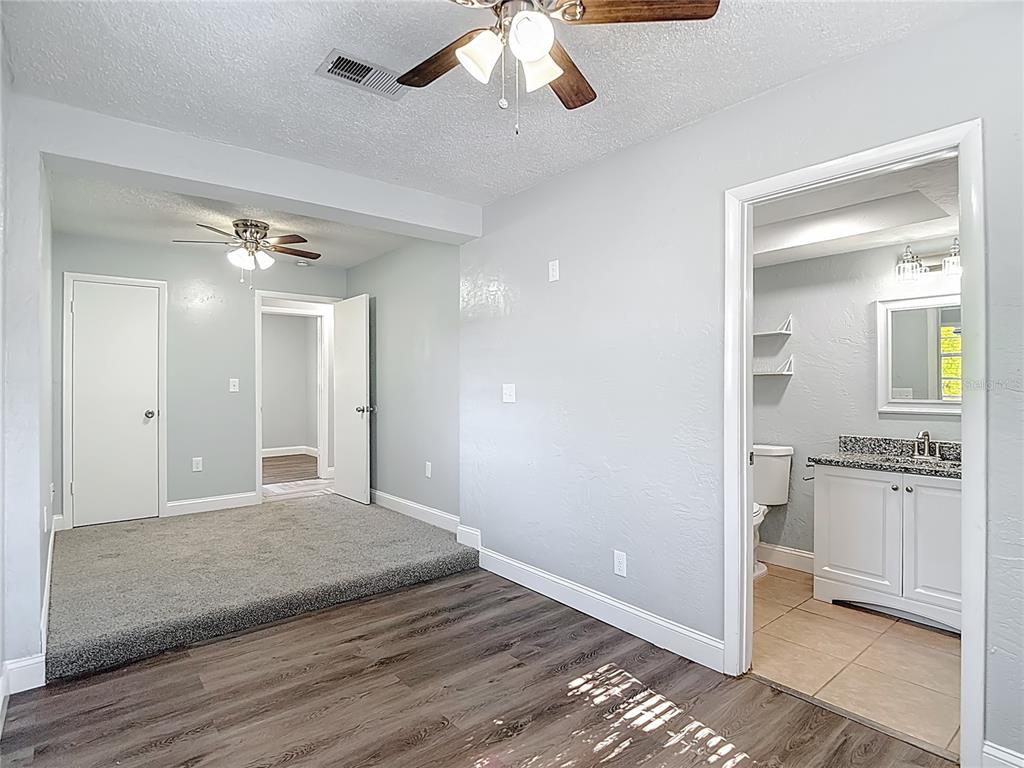 13156 Odham Street Spring Hill, FL 34609 - Photo 20 of 54 wooden floor in an empty room with a mirror