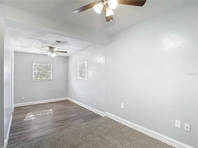a bathroom with a granite countertop sink and a toilet