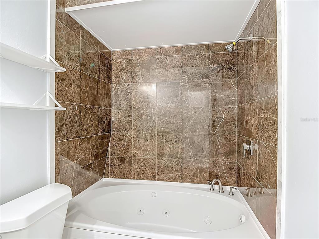 13156 Odham Street Spring Hill, FL 34609 - Photo 24 of 54 a bathroom with a bathtub and a toilet