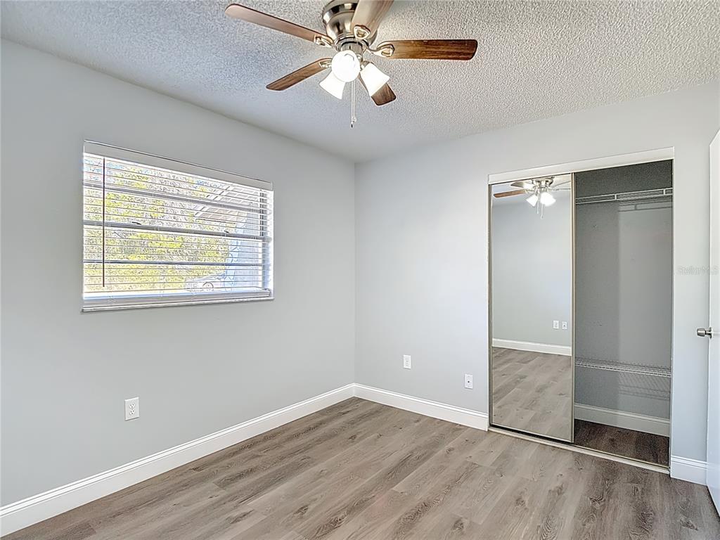 13156 Odham Street Spring Hill, FL 34609 - Photo 26 of 54 wooden floor in an empty room with a window