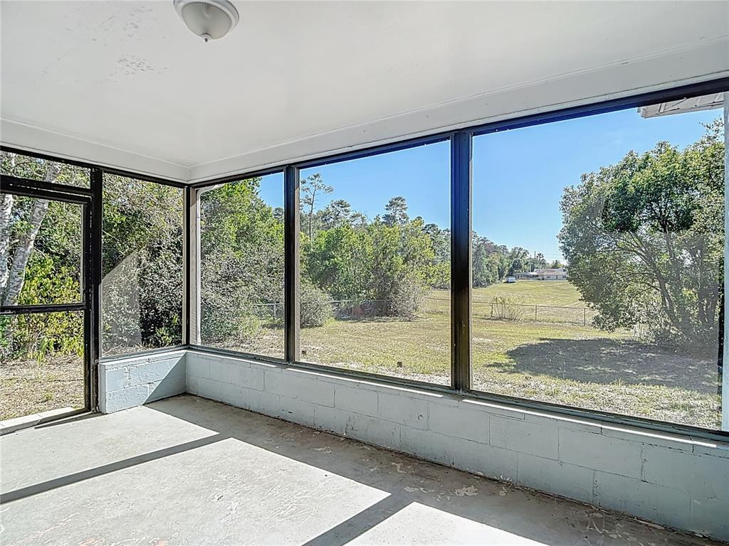 13156 Odham Street Spring Hill, FL 34609 - Photo 34 of 54 a view of a living room and floor to ceiling window