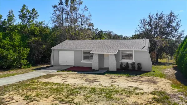 an aerial view of a house with swimming pool and ocean view