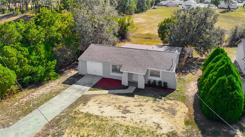 13156 Odham Street Spring Hill, FL 34609 - Photo 42 of 54 a view of a house with a yard