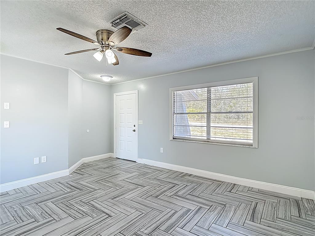 13156 Odham Street Spring Hill, FL 34609 - Photo 6 of 54 a view of an empty room with a window