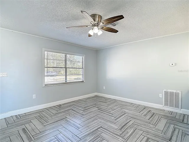 a kitchen with granite countertop a sink cabinets and wooden floor