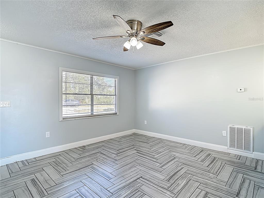 13156 Odham Street Spring Hill, FL 34609 - Photo 7 of 54 a view of a room with wooden floor and windows
