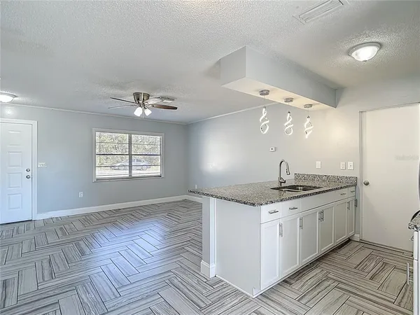 a kitchen with a sink and chandelier