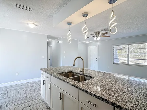 a kitchen with granite countertop a sink and a window