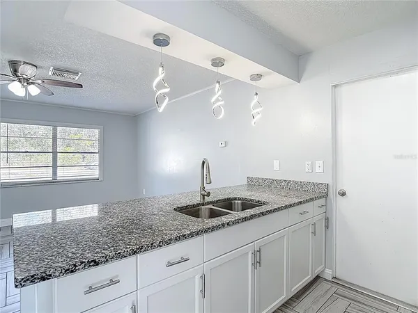 a view of a livingroom with kitchen view