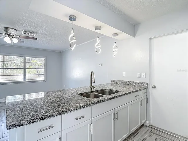 a view of a livingroom with kitchen view