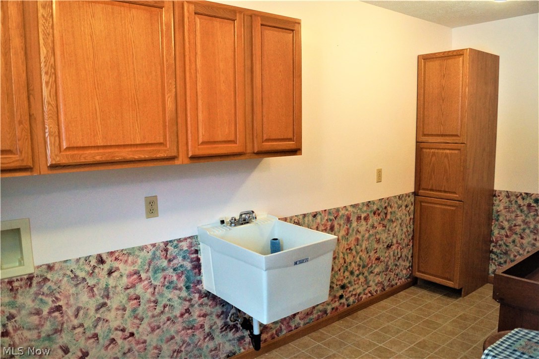 11044 Walker Road Minerva, OH 44657 - Photo 21 of 28 FIRST FLOOR LAUNDRY HAS GREAT STORAGE SPACE AND LAUNDRY SINK!