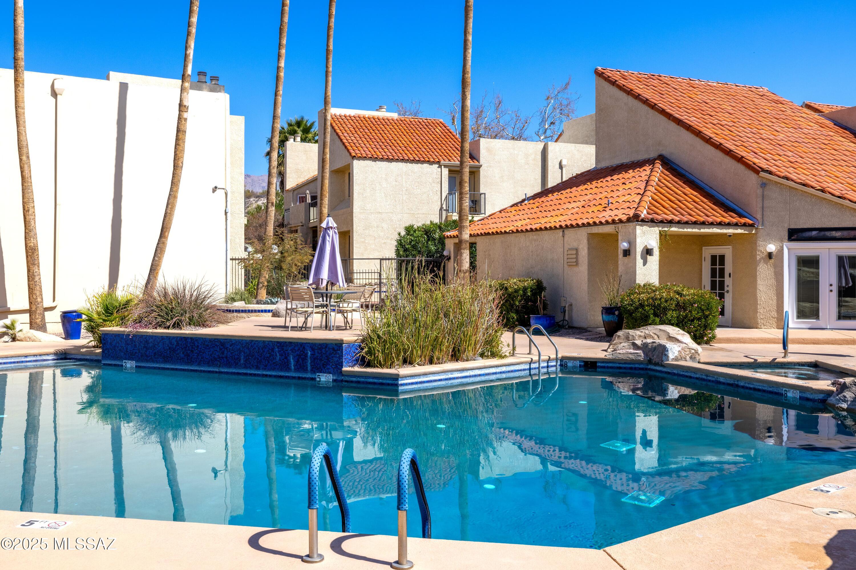 1200 East River Road, Unit G88 Tucson, AZ 85718 - Photo 12 of 13 a swimming pool view with a outdoor seating