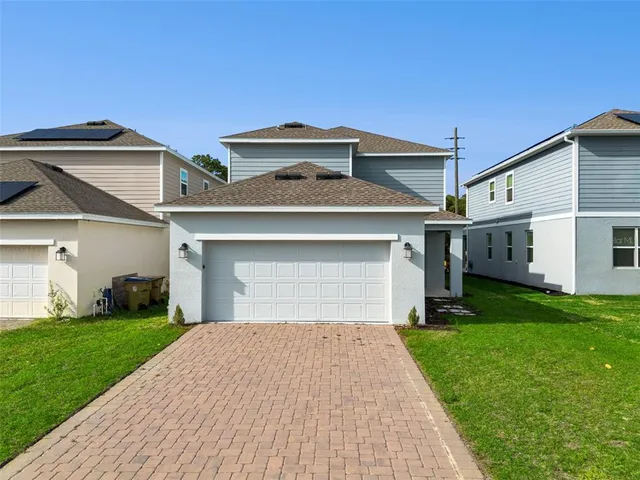 a front view of a house with a yard and garage
