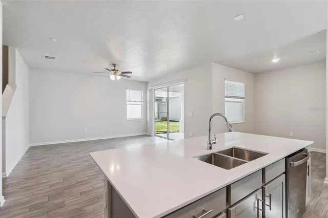 a kitchen with a sink a counter space and cabinets