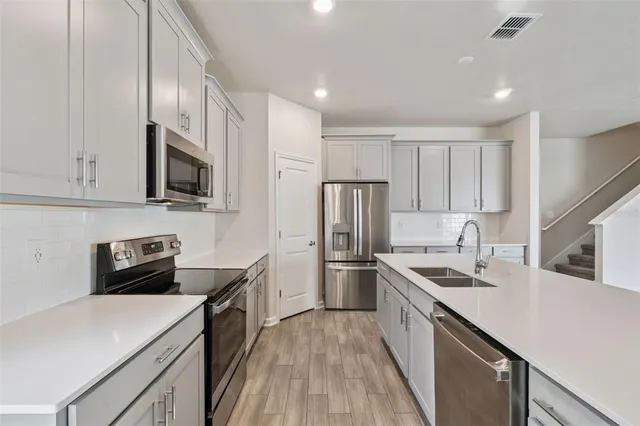 a kitchen with a sink a stove and refrigerator