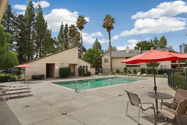 a backyard of a house with table and chairs