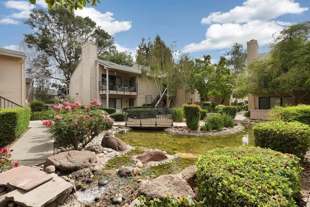 a view of a house with swimming pool and sitting area