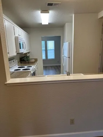 a view of kitchen with cabinets
