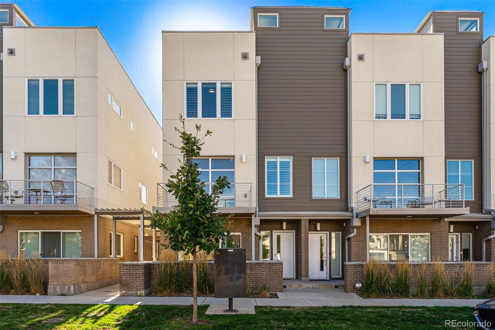 157 South Harrison Street Denver, CO 80209 - Photo 1 of 40 a front view of a residential apartment building with a yard