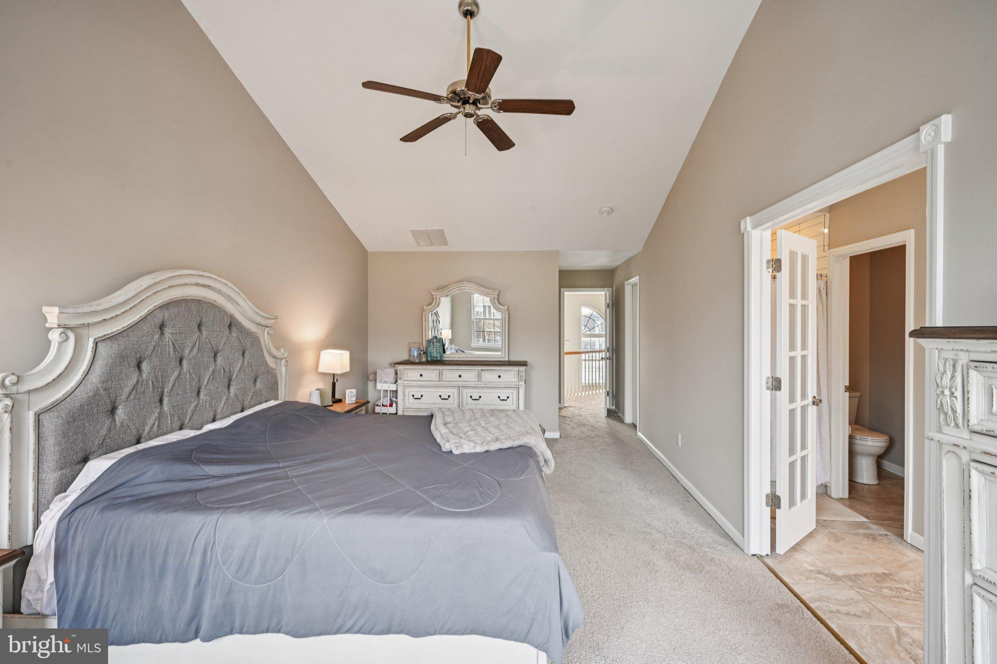 4 Cheyenne Court Burlington, NJ 08016 - Photo 16 of 34 a bedroom with a large bed and a chandelier