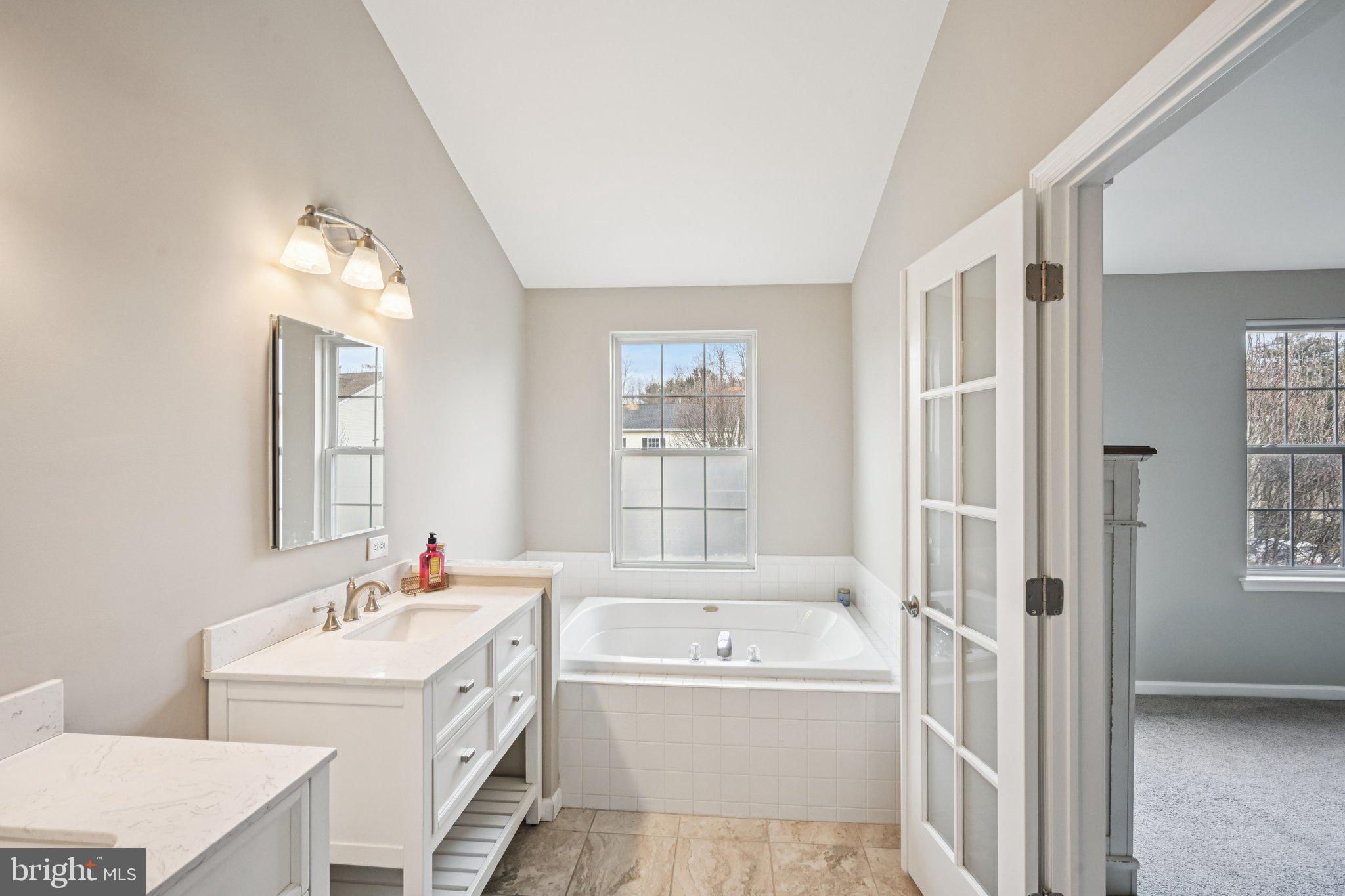 4 Cheyenne Court Burlington, NJ 08016 - Photo 18 of 34 a bathroom with a tub sink and mirror