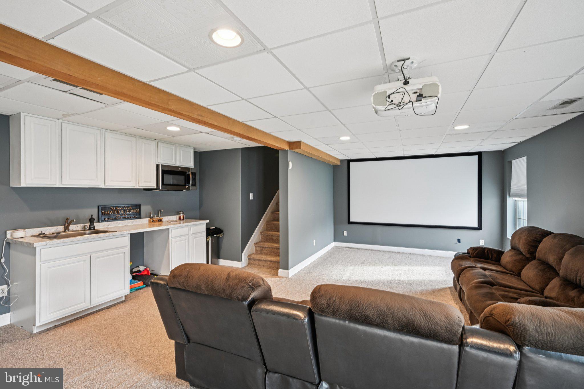 4 Cheyenne Court Burlington, NJ 08016 - Photo 25 of 34 a living room with stainless steel appliances kitchen island furniture a chandelier and a projector screen