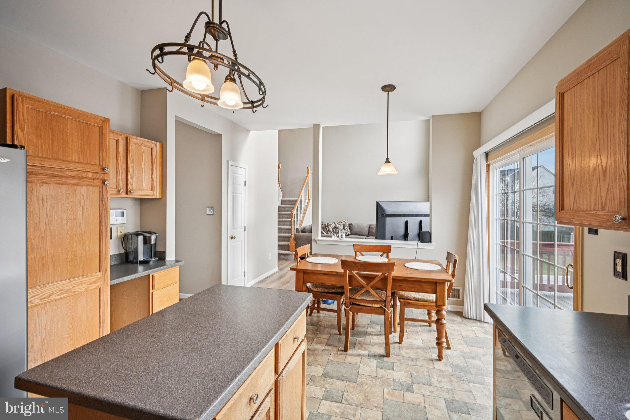 4 Cheyenne Court Burlington, NJ 08016 - Photo 10 of 34 a dining room with wooden floor a chandelier a wooden table and chairs