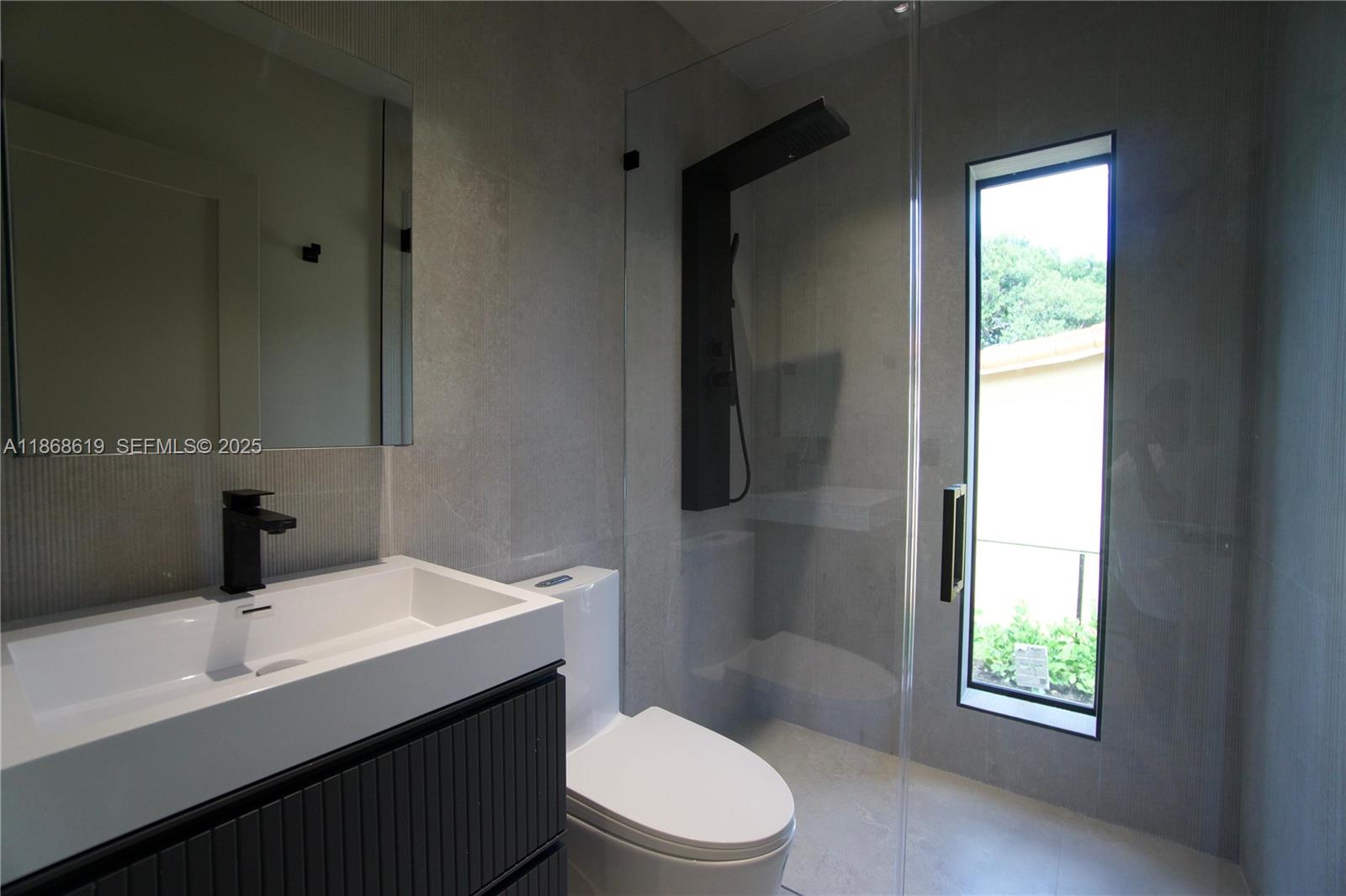 2155 Southwest 25th Terrace Miami, FL 33133 - Photo 15 of 20 a bathroom with a sink a toilet a window and shower