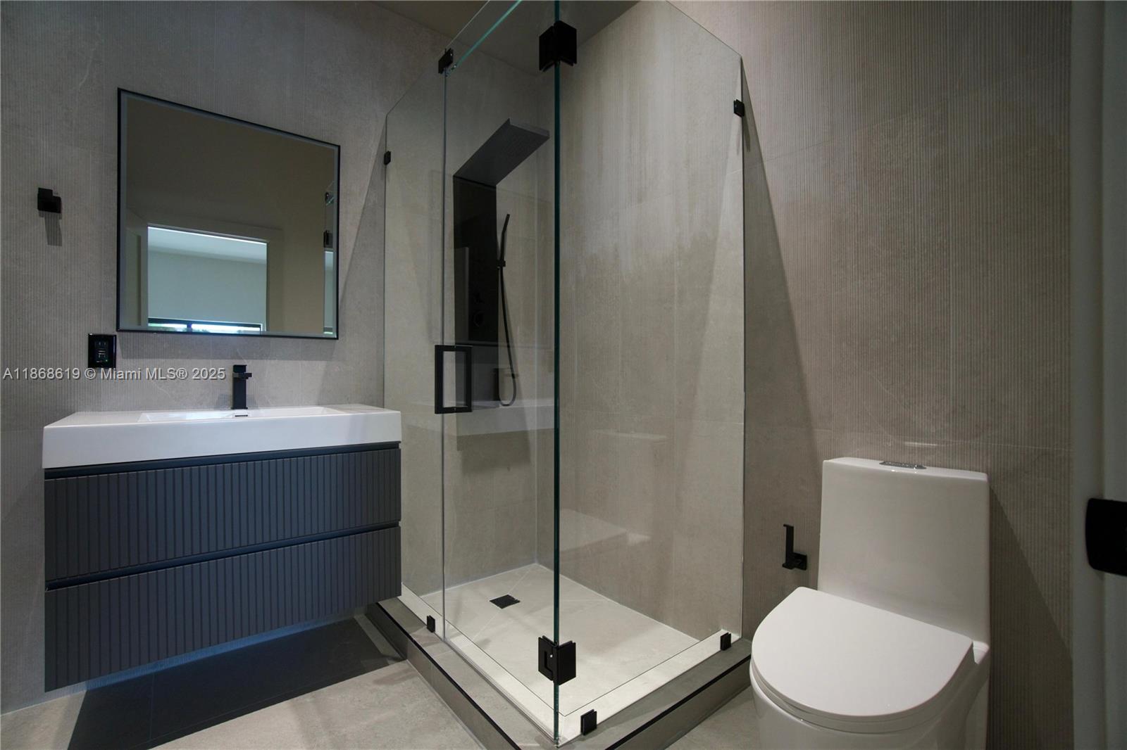 2155 Southwest 25th Terrace Miami, FL 33133 - Photo 16 of 20 a bathroom with a sink mirror vanity and toilet