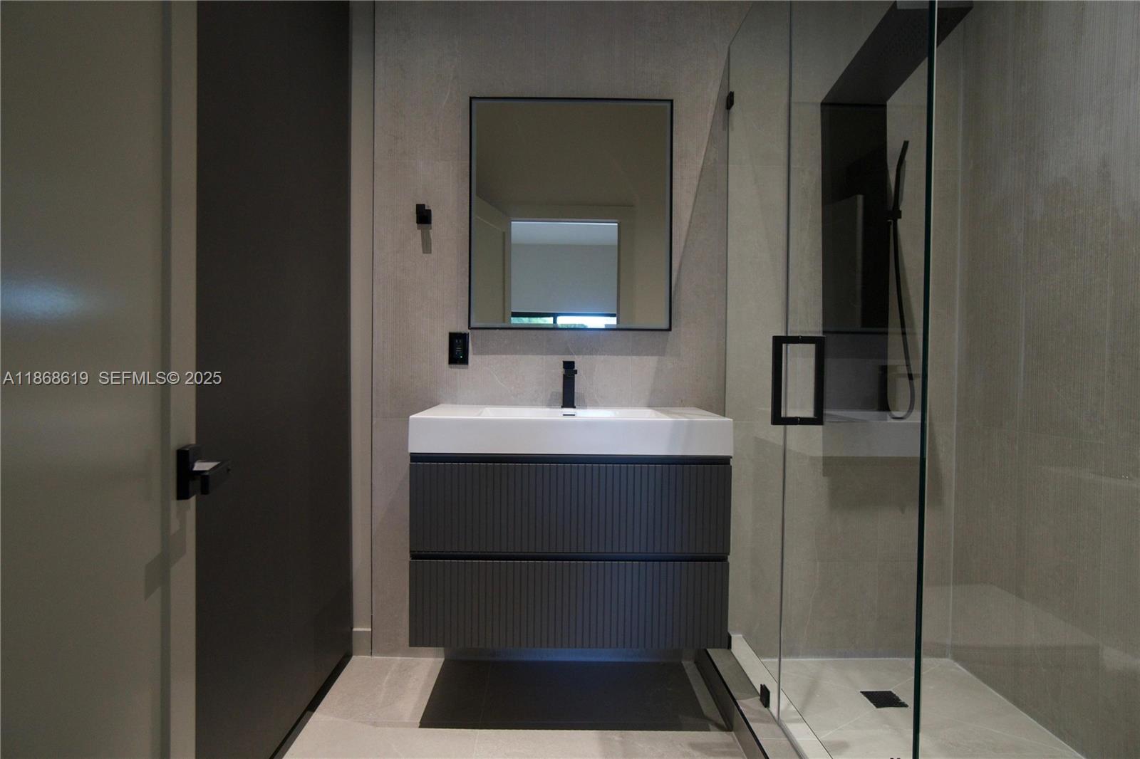 2155 Southwest 25th Terrace Miami, FL 33133 - Photo 17 of 20 a bathroom with a sink and a mirror