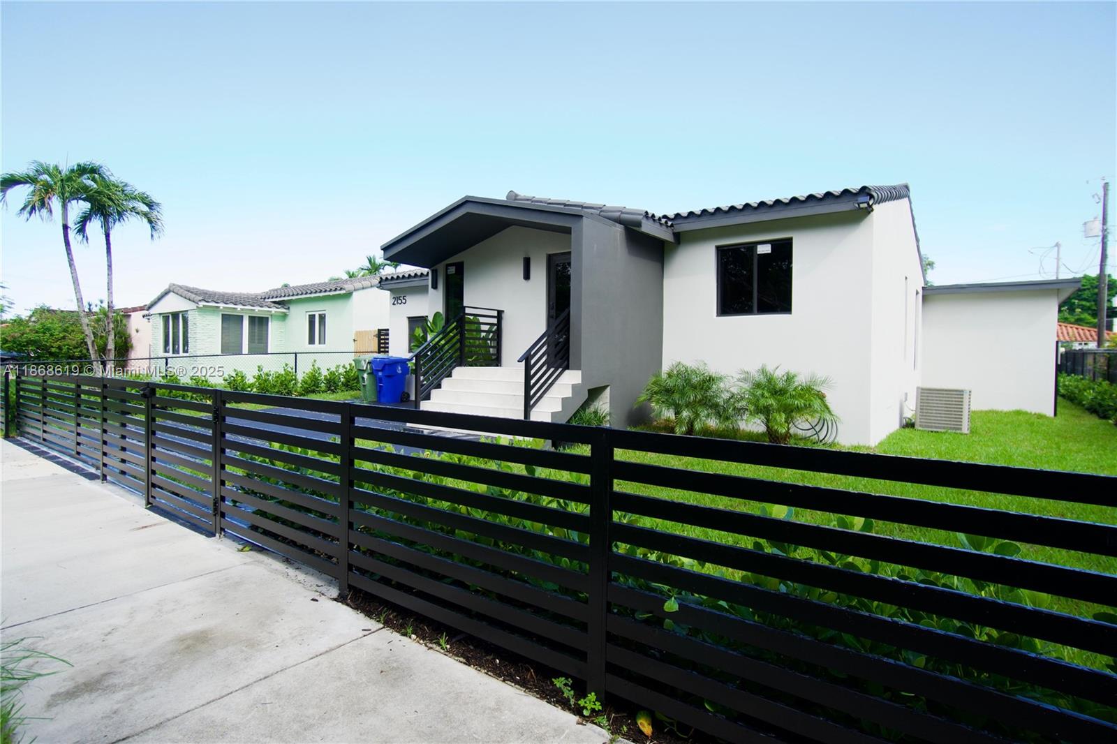 2155 Southwest 25th Terrace Miami, FL 33133 - Photo 18 of 20 a front view of a house with a yard